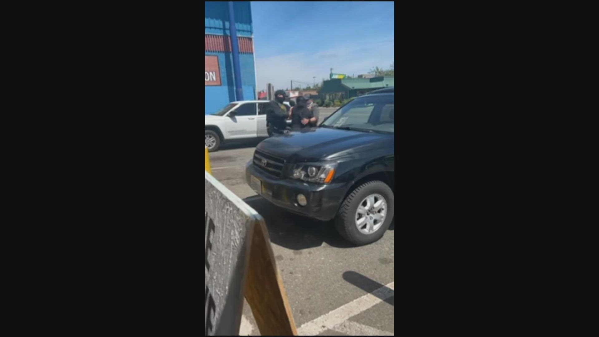 Immigration and Customs Enforcement has not confirmed whether the masked people wearing vests in the video are authorized officials.
